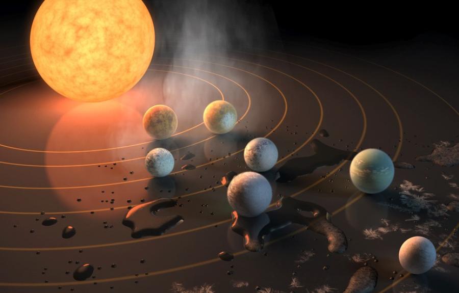 This artist’s concept portrays the seven rocky exoplanets within the TRAPPIST-1 system, located about 39 light-years from Earth.